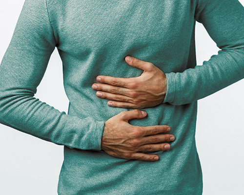 GUT PROBLEMS Man holding stomach due to gut problems